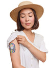 Person wearing colorful Dexcom G7 sensor patch on arm, emphasizing secure and stylish protection with Childhood Memories design.