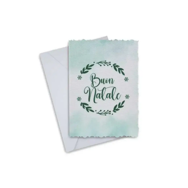 Elegant Christmas greeting card with "Buon Natale" inscription, featuring a festive wreath design, accompanied by an envelope.