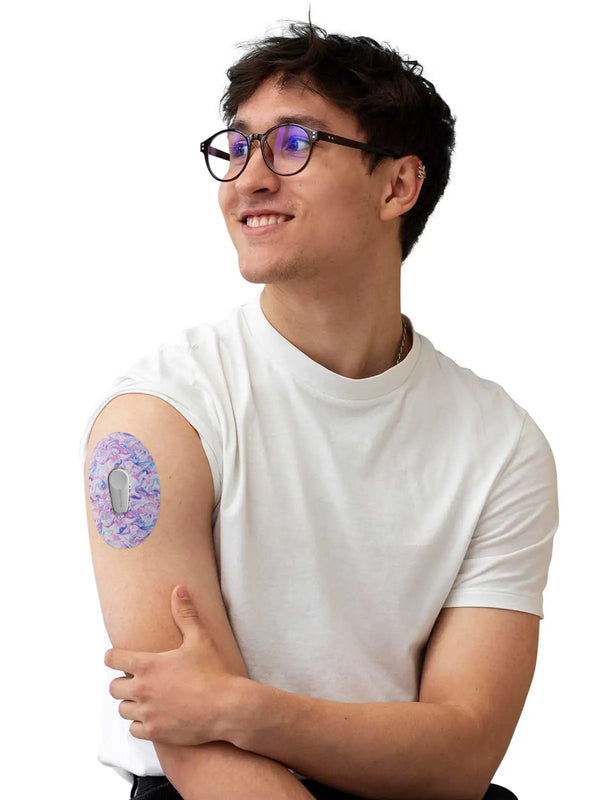 Man wearing Dexcom G6 adhesive patch from the Patch Me UP! Spring collection on his upper arm, showcasing its vibrant design and secure fit.