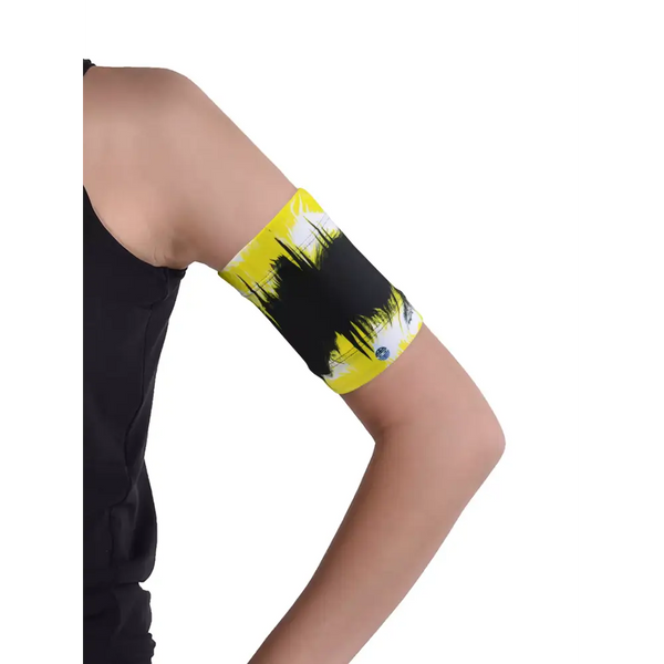 Glucose monitor and insulin pump armband in vibrant yellow and black, worn on upper arm for secure diabetes device management.