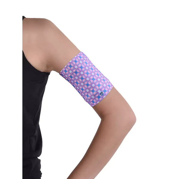 Glucose monitor and insulin pump armband in pink geometric pattern, worn on upper arm for diabetes device protection and comfort.