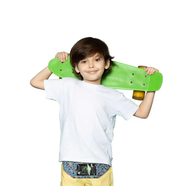 Child wearing Dia-Twin Pocket Belt for insulin pump and phone, holding a green skateboard.