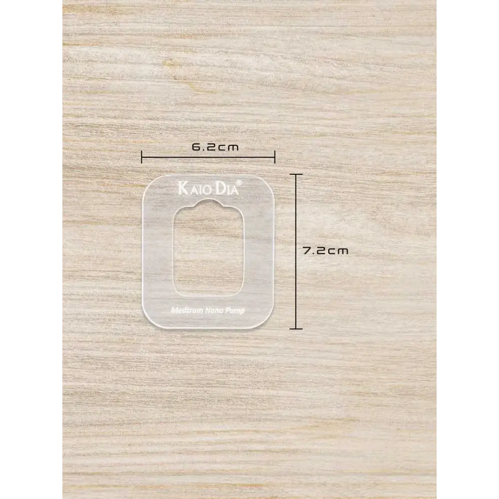 Insulin patch pump template by Kaio-Patch on wooden background, showing dimensions of 6.2cm by 7.2cm.