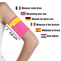 Child's arm wearing bright pink glucose sensor armband with measuring tape showing 11.5 cm circumference for size guidance