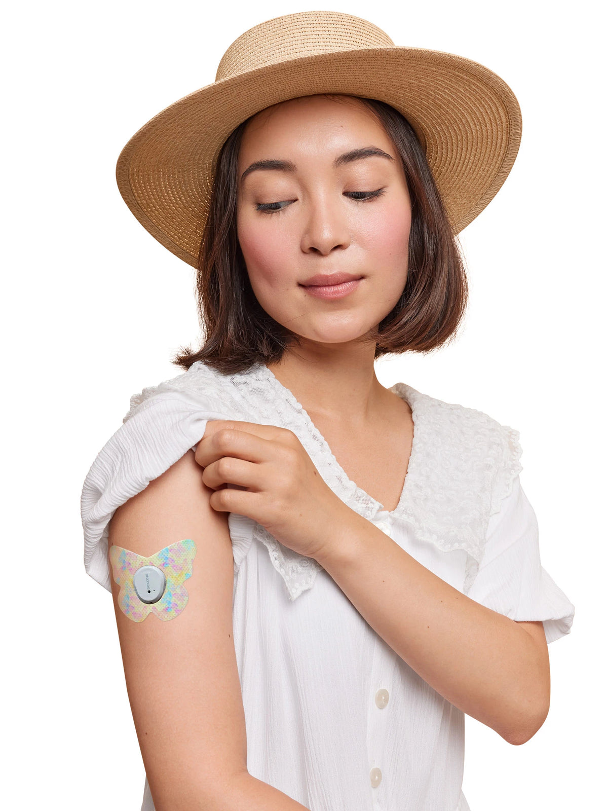 Fixierpflaster für Dexcom G7, Form Schmetterling, am Arm einer Frau