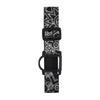 GlucoMen Day CGM armband adjustable black and white patterned strap for blood glucose sensor with secure fit and reusable tin box.