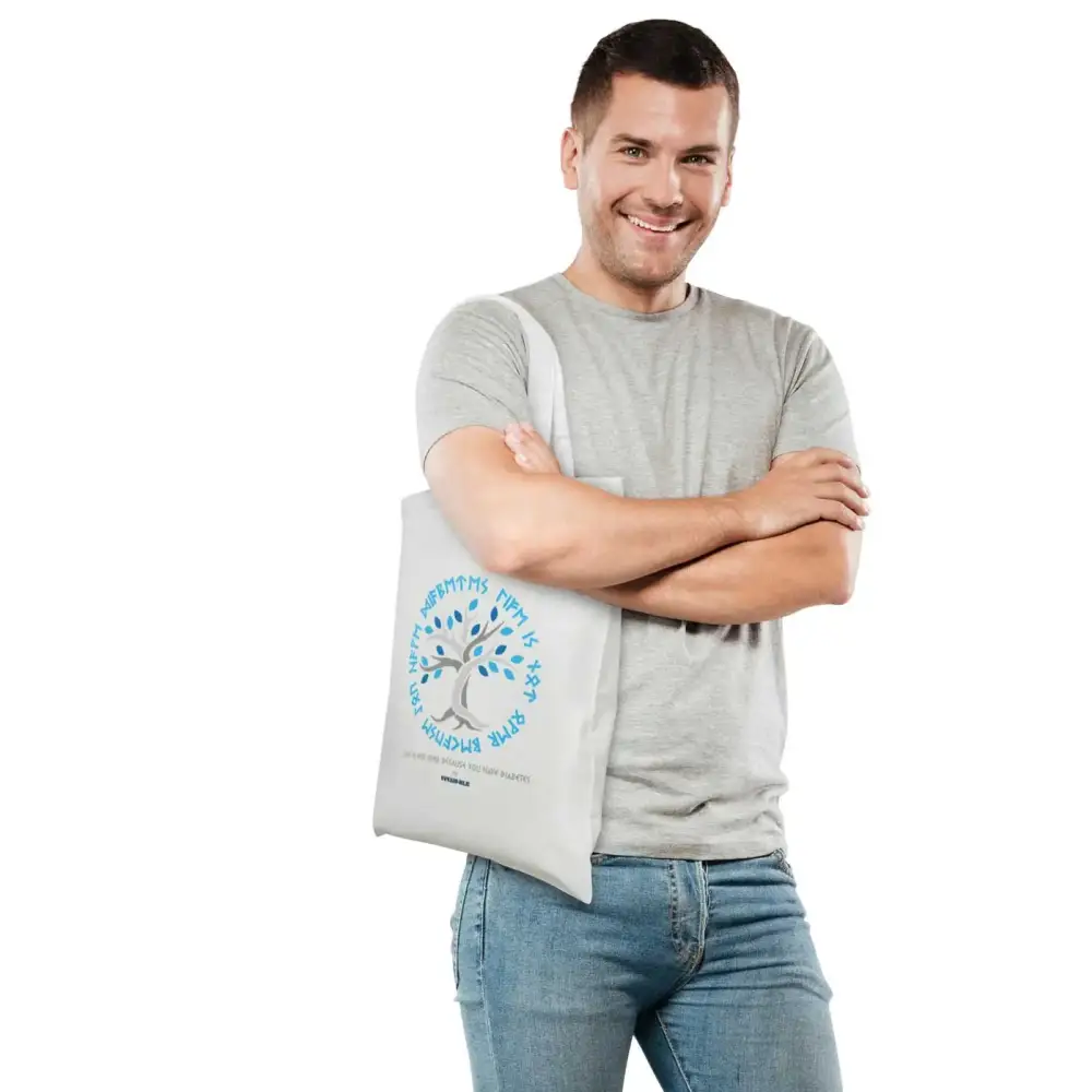 Diabetes Awareness Tote Bag with Viking symbols and rune texts, modeled by a smiling man in a gray shirt.