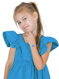 Child wearing a reversible Type 1 diabetes awareness wristband with vibrant summer patterns.