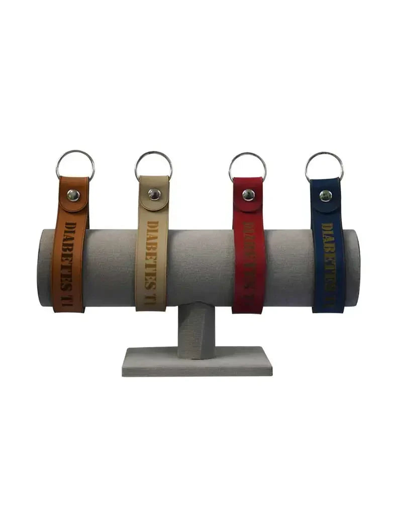 Diabetes Type 1 Leather Keychain - Kaio-Key Hanger in various colors displayed on stand.