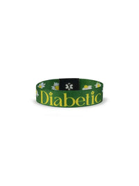Reversible Type 1 Diabetes Awareness Wristband for Children with daisies, "Diabetic" text, green background.